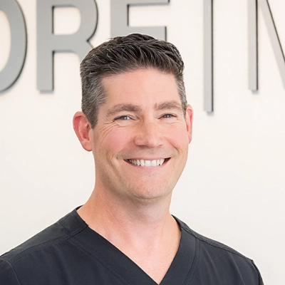 A headshot of Dr. Ryan Hasenclever, a chiropractor at Core Med.